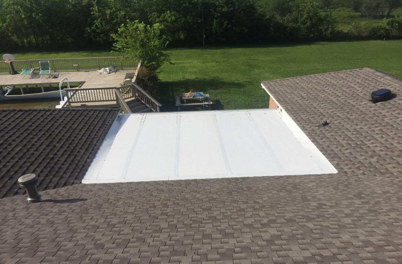 A white tarp covering the roof of a house.